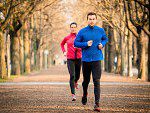 A man and woman running in the park.